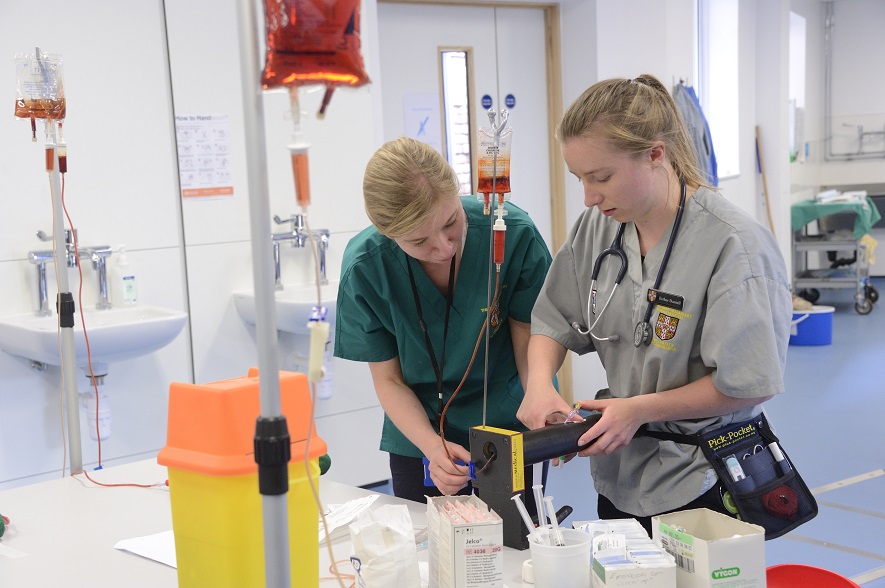 Catherine Wager, Clinical Skills Facilitor, with a student practising IV techniques
